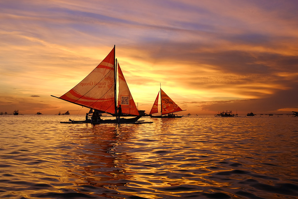 Sail boats and Sunset in Boracay. Best Summer Destinations in Philippines